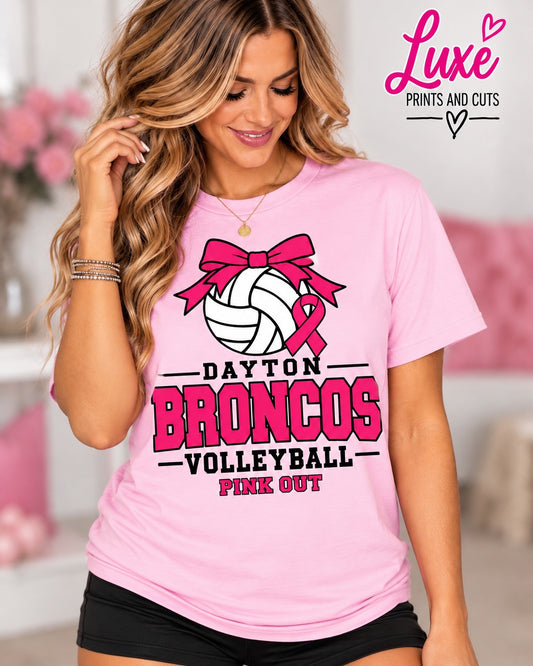 Woman wearing light pink Dayton Broncos Volleyball Pink Out bow design shirt with Luxe branding