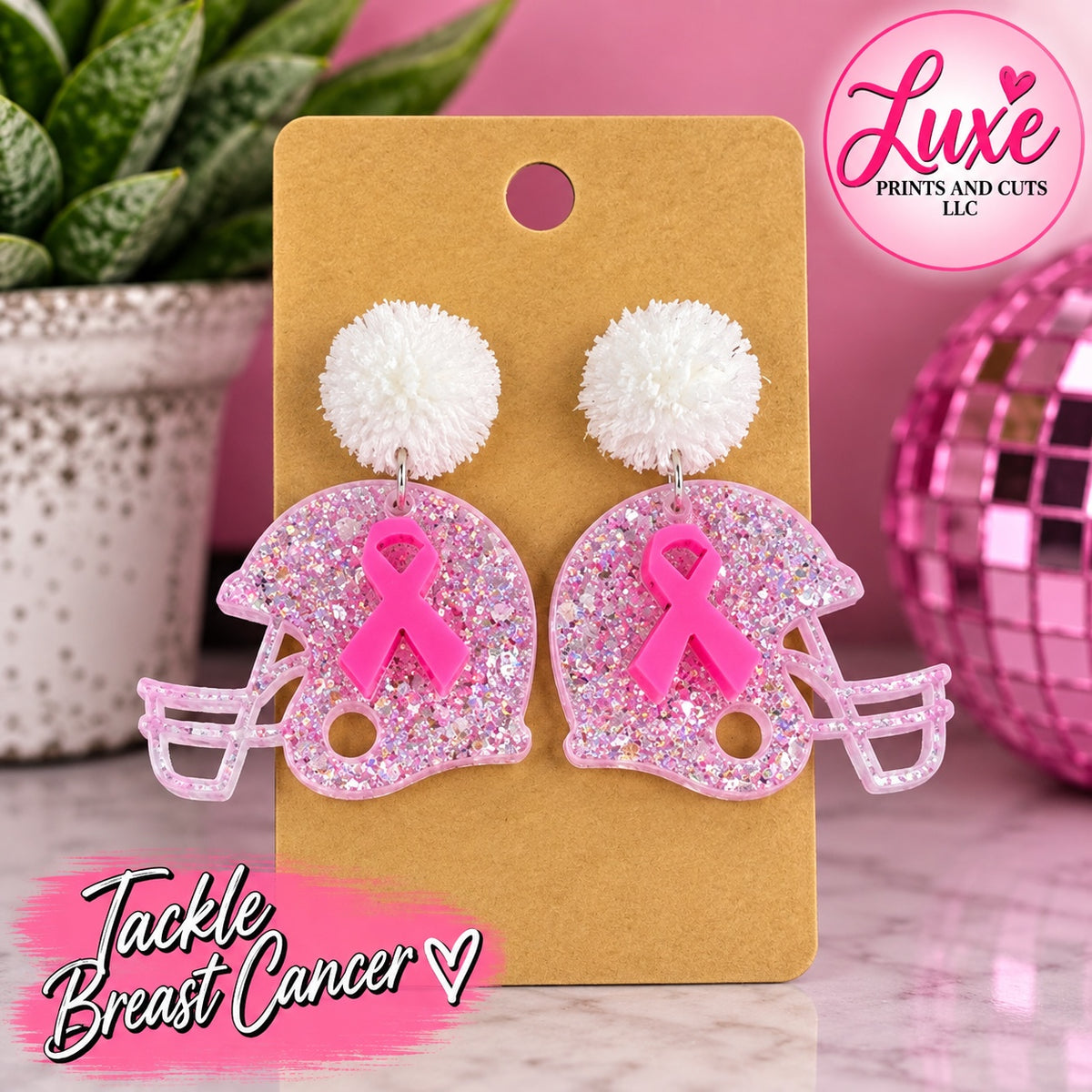 Pink glitter football helmet earrings with white pom poms and breast cancer ribbons