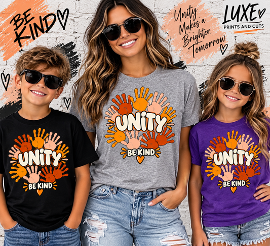 Woman and children wearing Unity Be Kind handprint shirts